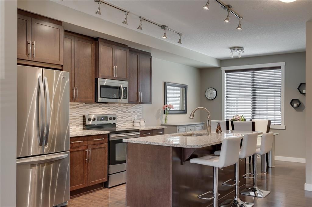 Granite kitchen with stainless steel appliances and a large central island.
