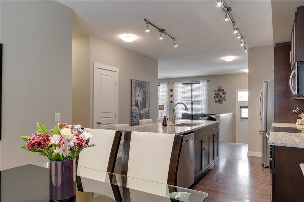 Single-level flow connecting kitchen, dining, and living.