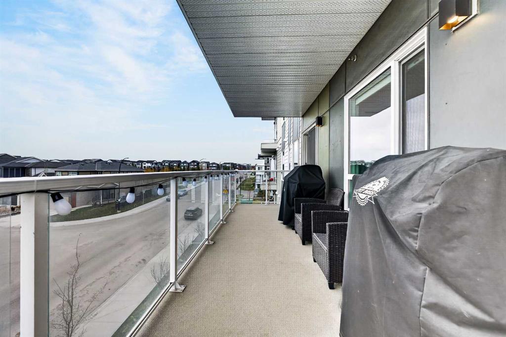 West-facing wraparound balcony with patio seating and neighbourhood views