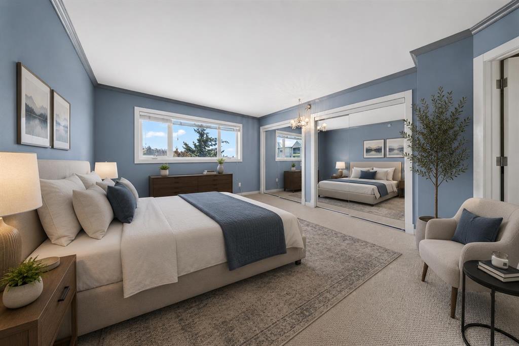 Spacious primary bedroom with large windows and natural light