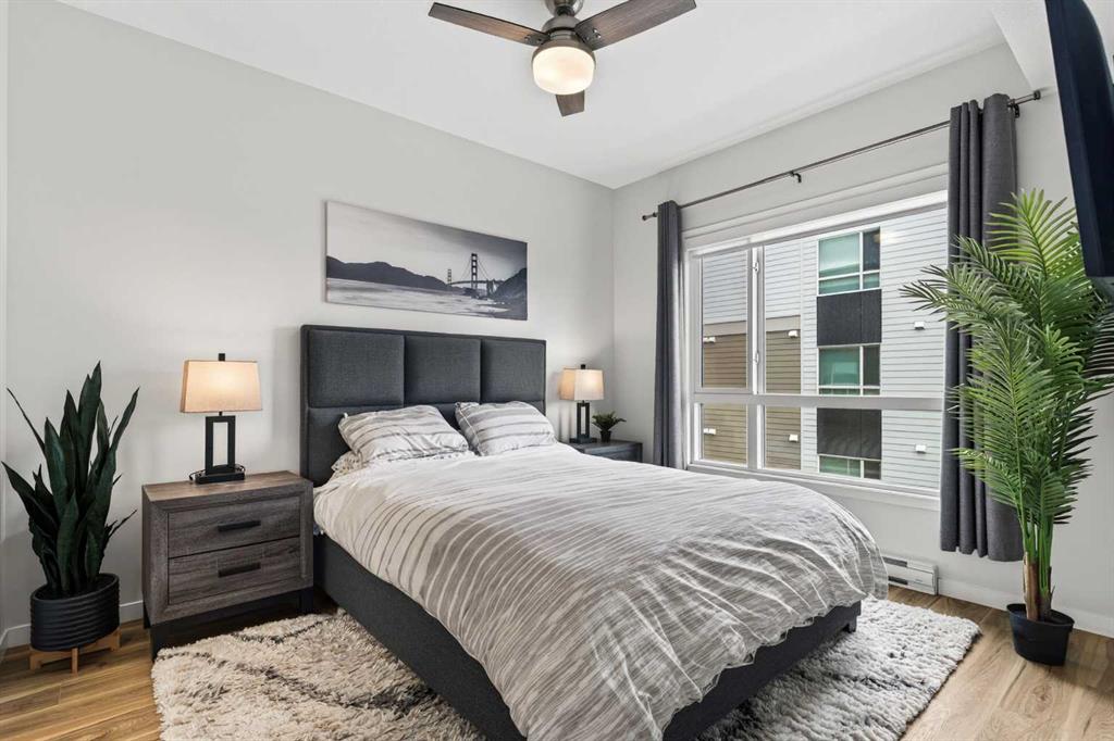 Primary bedroom with upholstered headboard and large window