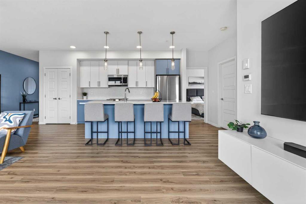 Two-tone kitchen with island seating and stainless appliances