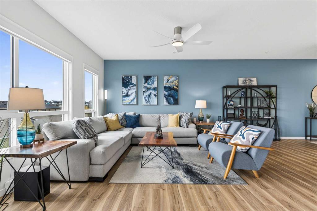 Bright living room with blue accent wall and west-facing windows
