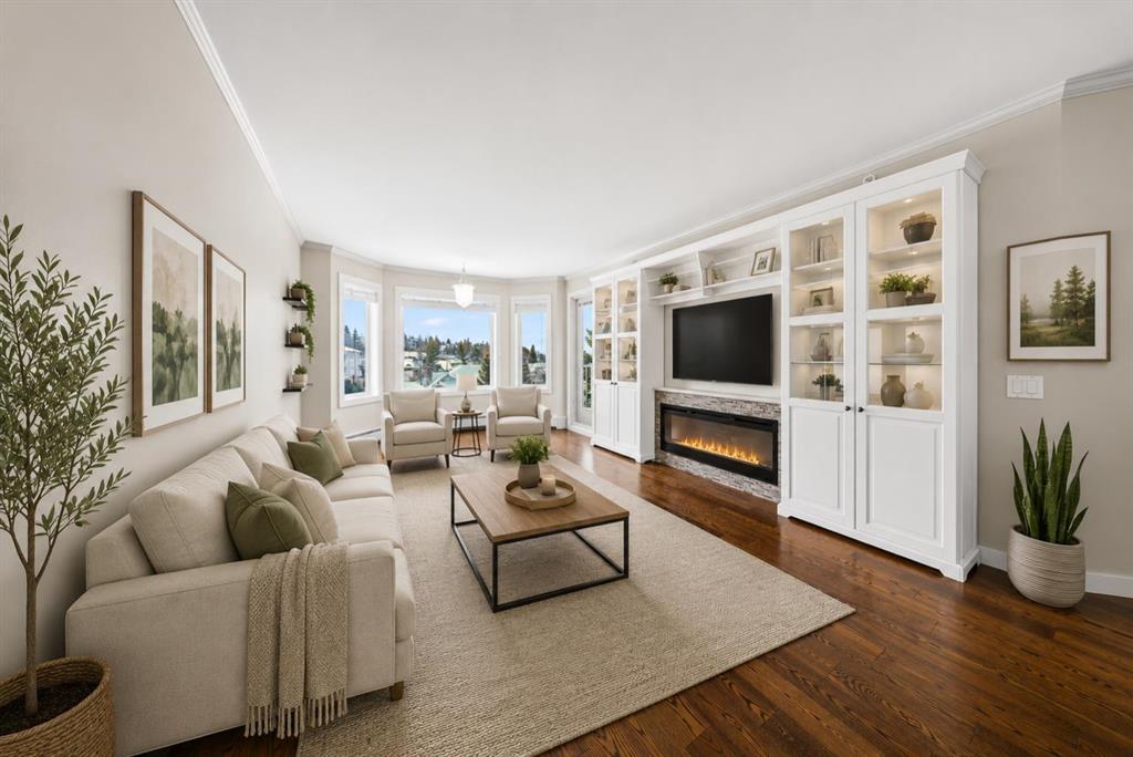 Bright living room with fireplace and built-in shelving at 3402 Hawksbrow Point NW