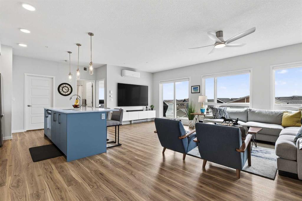 Open-concept kitchen, dining, and living area with vinyl plank flooring