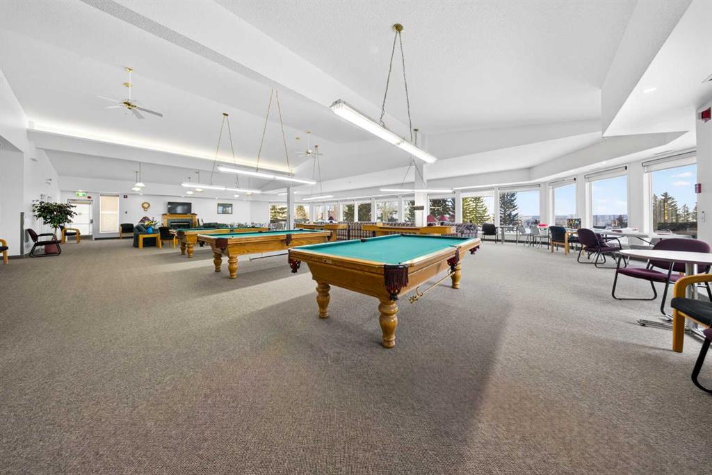 Community recreation room with billiards tables and seating area